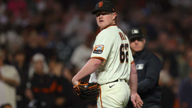 Logan Webb looks back at the Padres dugout.